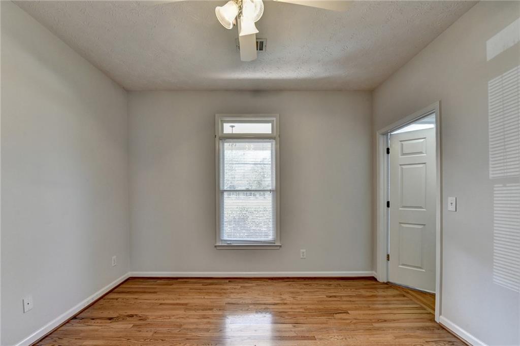 1622 New Hope Road Lawrenceville, GA 30045 - Photo 43 of 110 a view of an empty room with wooden floor and a window
