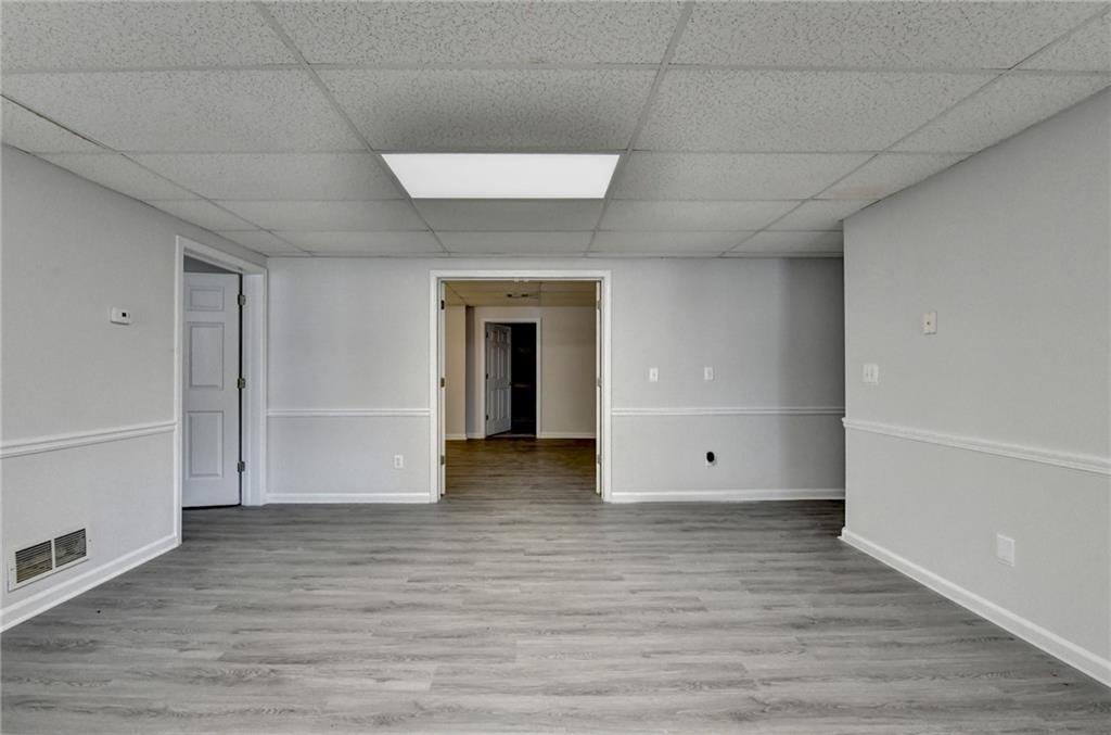 1622 New Hope Road Lawrenceville, GA 30045 - Photo 60 of 110 a view of empty room with wooden floor and cabinet