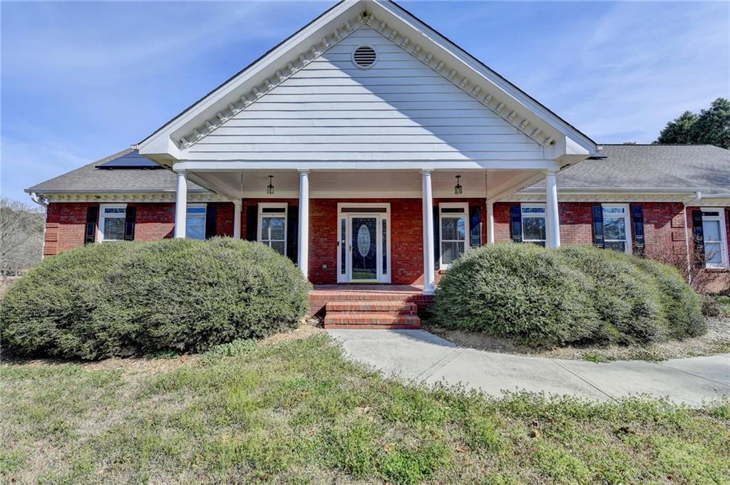 1622 New Hope Road Lawrenceville, GA 30045 - Photo 6 of 110 a front view of a house with garden
