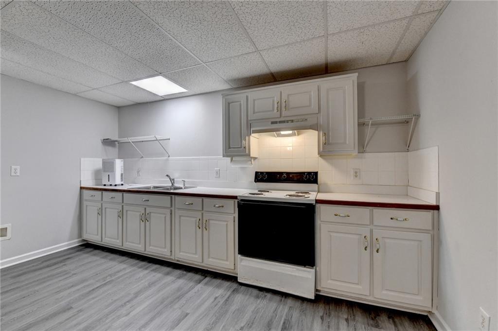 1622 New Hope Road Lawrenceville, GA 30045 - Photo 65 of 110 a kitchen with granite countertop white cabinets and white appliances