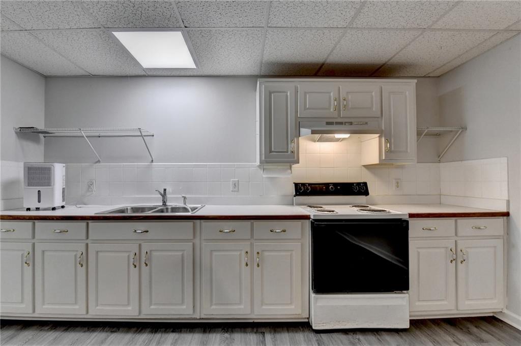 1622 New Hope Road Lawrenceville, GA 30045 - Photo 66 of 110 a kitchen with granite countertop white cabinets and white appliances