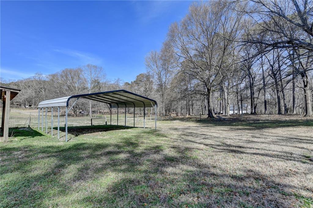 1622 New Hope Road Lawrenceville, GA 30045 - Photo 86 of 110 a view of a big house with a big yard and large trees