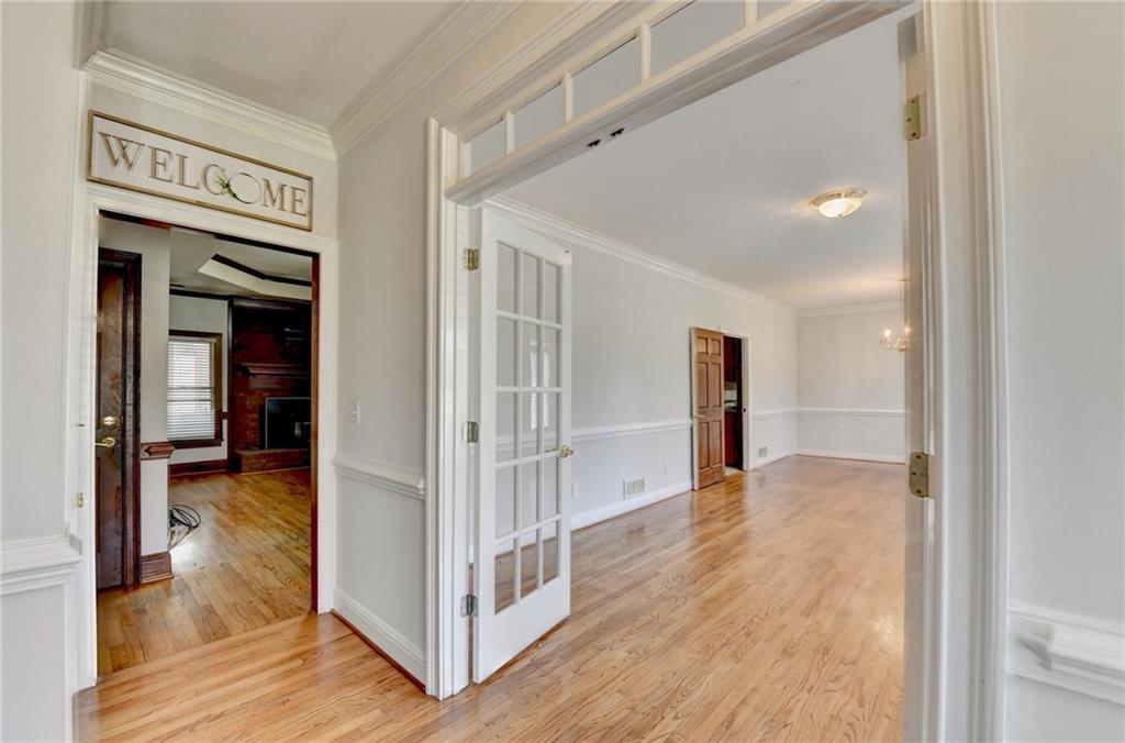 1622 New Hope Road Lawrenceville, GA 30045 - Photo 10 of 110 a view of a hallway with wooden floor and staircase