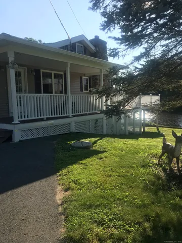 a view of a house with backyard and sitting area