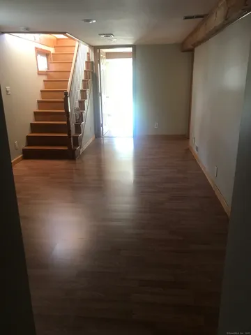 a view of a room with stairs and a window