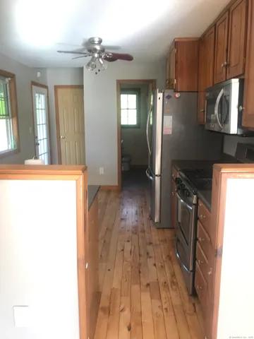 a kitchen with granite countertop a refrigerator and a stove