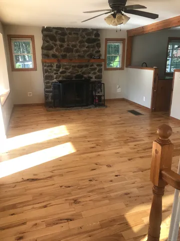 a view of a livingroom with an empty space and a fireplace