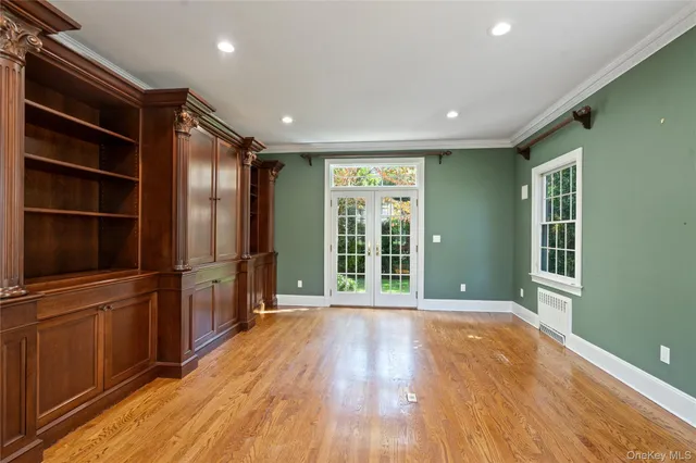 a view of kitchen with stainless steel appliances wooden floor and window