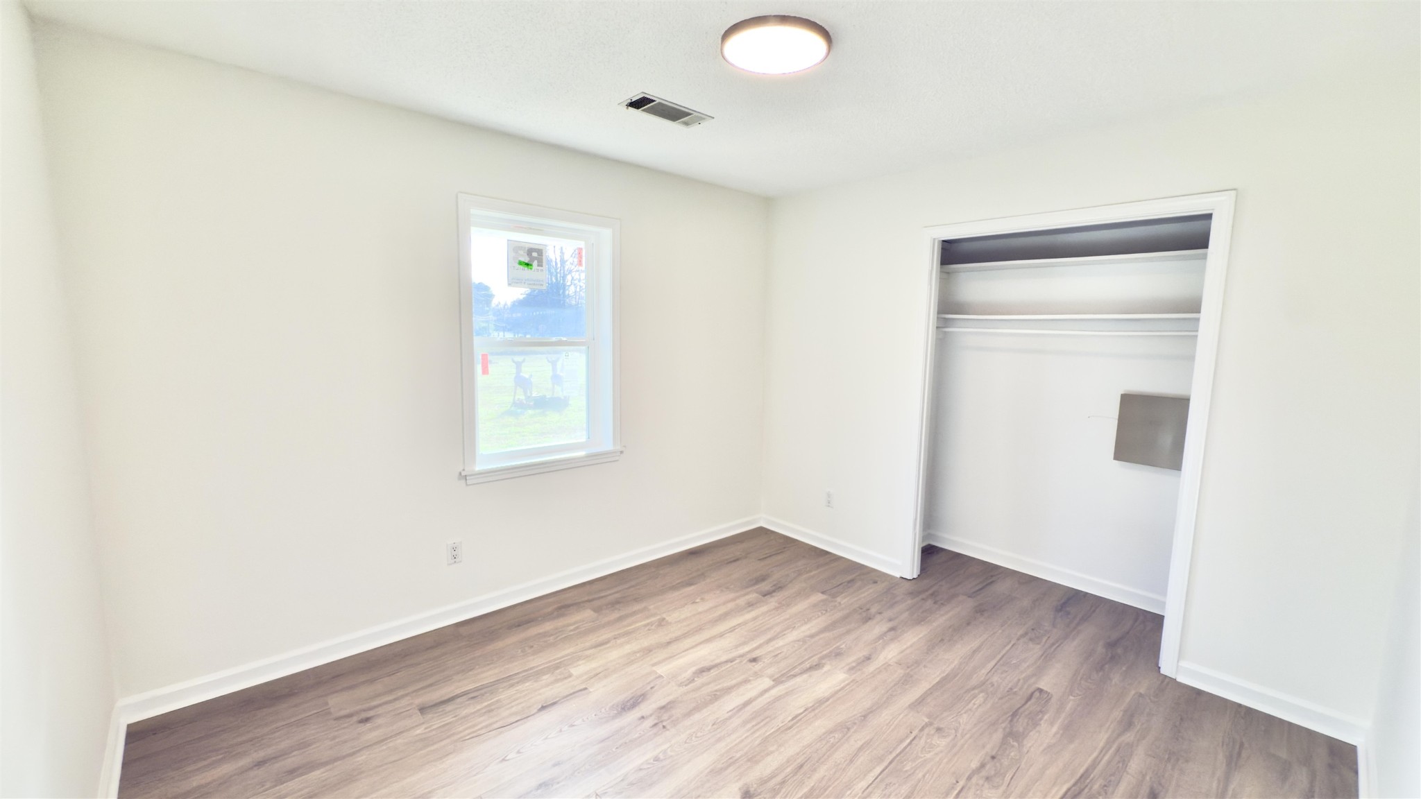 9000 Jack Bond Road Arlington, TN 38002 - Photo 15 of 19 a view of an empty room with wooden floor and a window