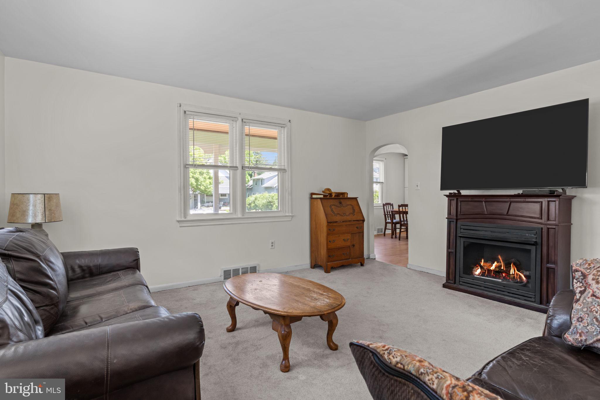 339 Pitman Avenue Pitman, NJ 08071 - Photo 11 of 25 a living room with furniture a flat screen tv and a fireplace