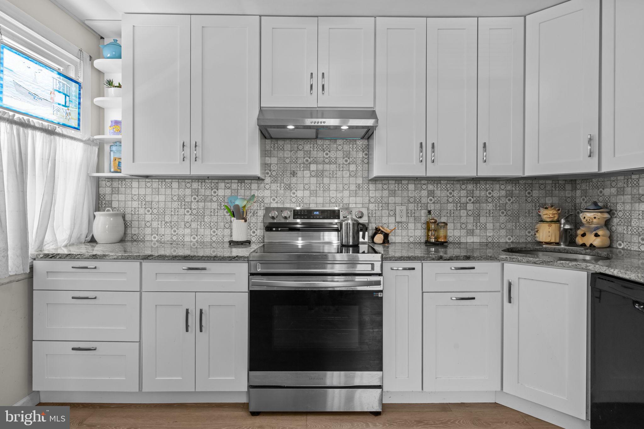 339 Pitman Avenue Pitman, NJ 08071 - Photo 5 of 25 a kitchen with granite countertop white cabinets and stainless steel appliances