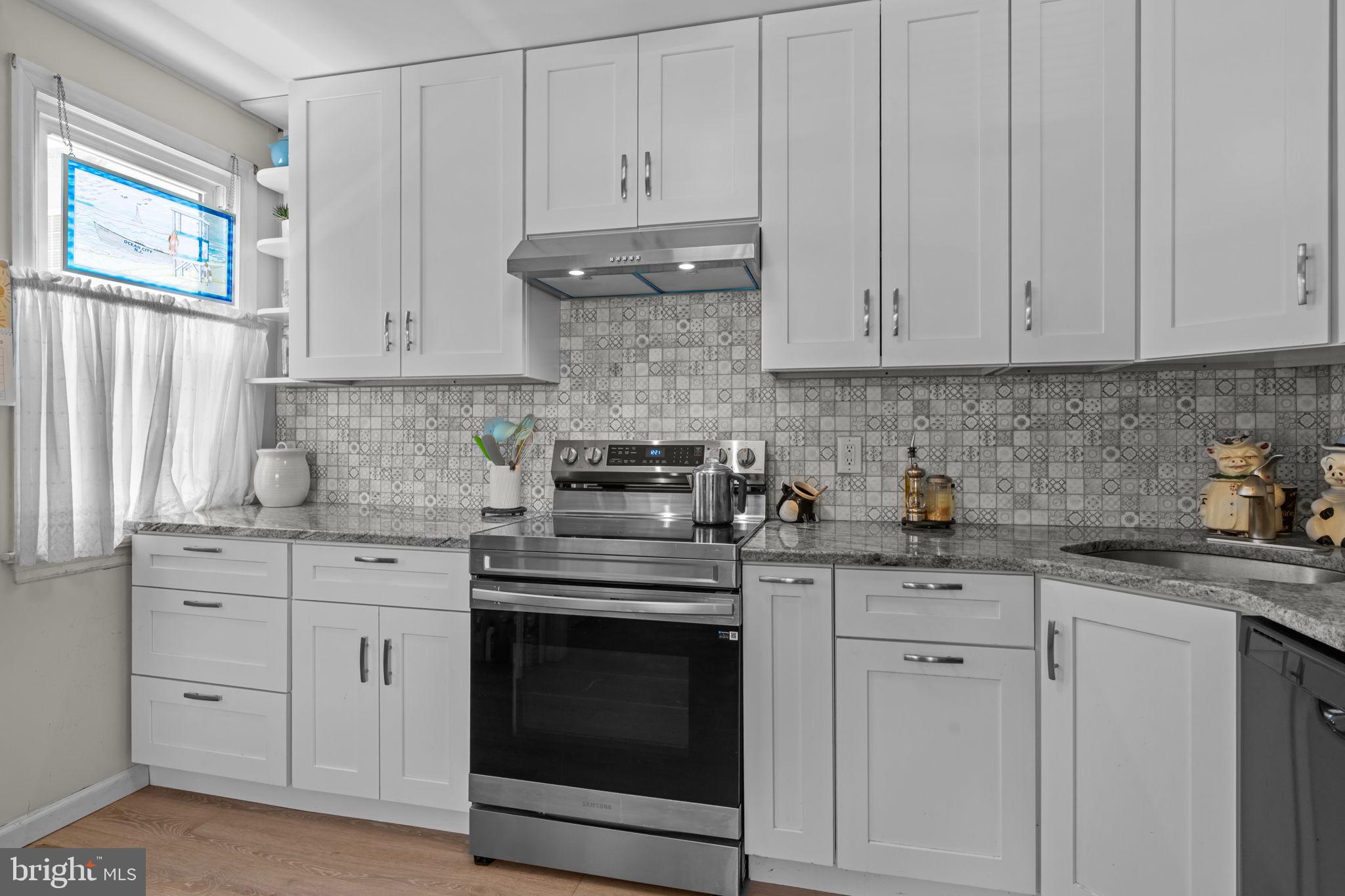 339 Pitman Avenue Pitman, NJ 08071 - Photo 7 of 25 a kitchen with granite countertop white cabinets and white appliances