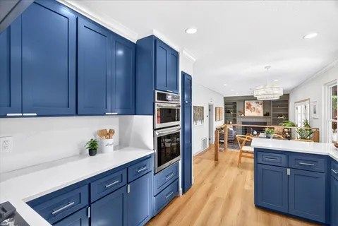 a kitchen with stainless steel appliances granite countertop wooden cabinets a refrigerator and a stove top oven