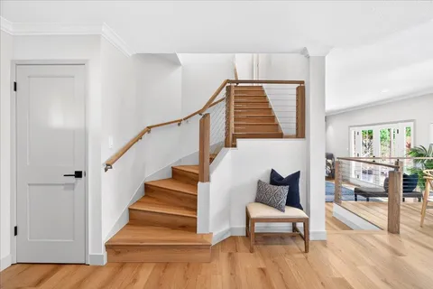 a view of entryway and hall with wooden floor