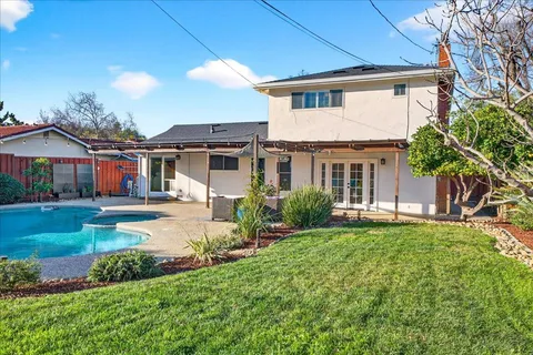 a view of a house with a yard porch and sitting area