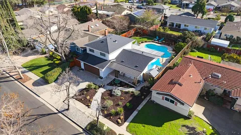 an aerial view of a house with a yard