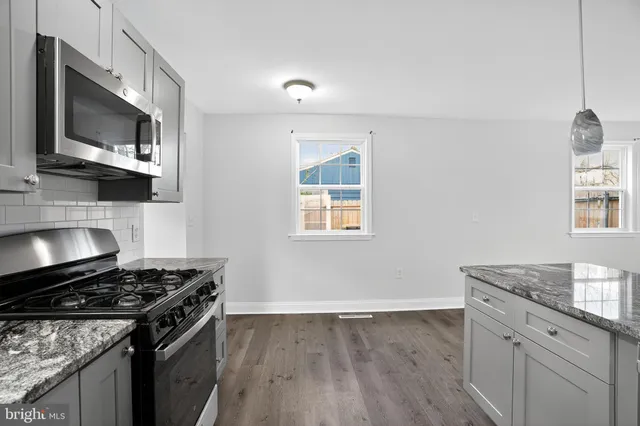 a kitchen with a stove and a microwave