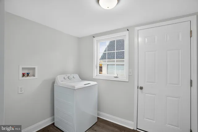 a utility room with cabinets washer and dryer
