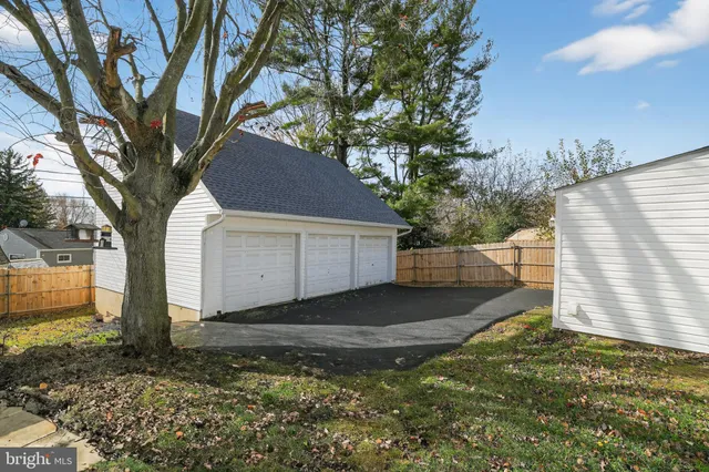 a view of a yard with a house and a large tree