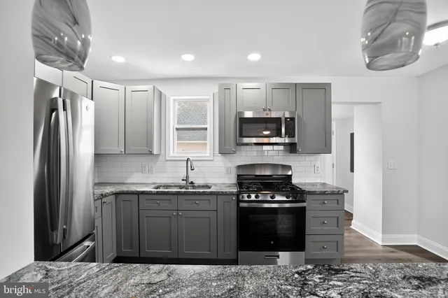 a kitchen with a sink stove and refrigerator