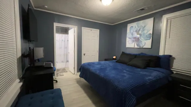 a bed room with a bed and a large mirror