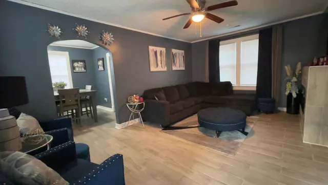 a living room with furniture and wooden floor