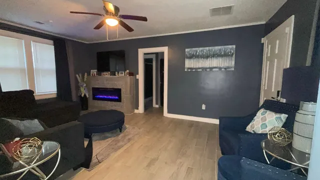 a living room with furniture and a flat screen tv
