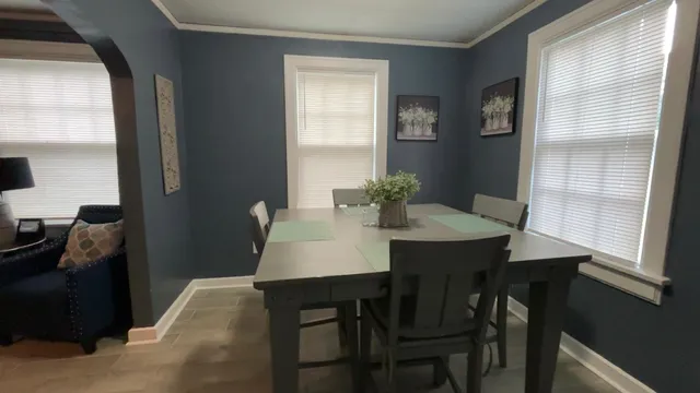 a dining room with furniture and window