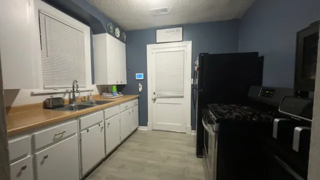 a kitchen with a refrigerator and a sink