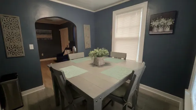a dining room with furniture and window