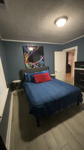 a bed sitting in a bedroom next to a window