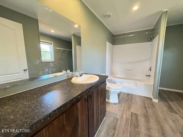 a bathroom with a granite countertop toilet and a sink