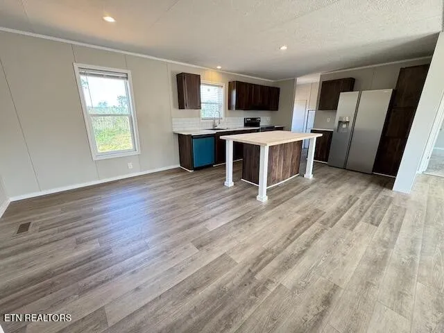 a view of kitchen with refrigerator microwave and cabinets