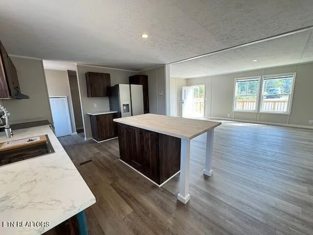 a kitchen with stainless steel appliances kitchen island sink stove and refrigerator