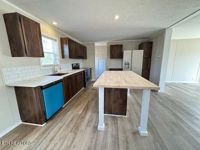 a kitchen with a sink cabinets and wooden floor