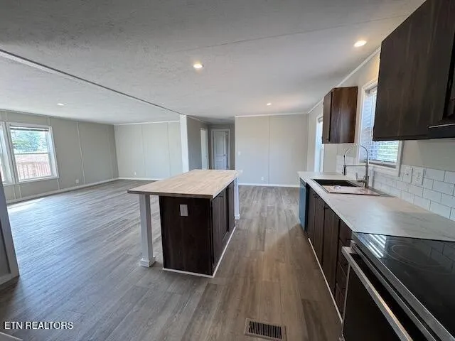 a kitchen with a sink and wooden floor