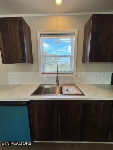 a kitchen with a sink a window and a microwave