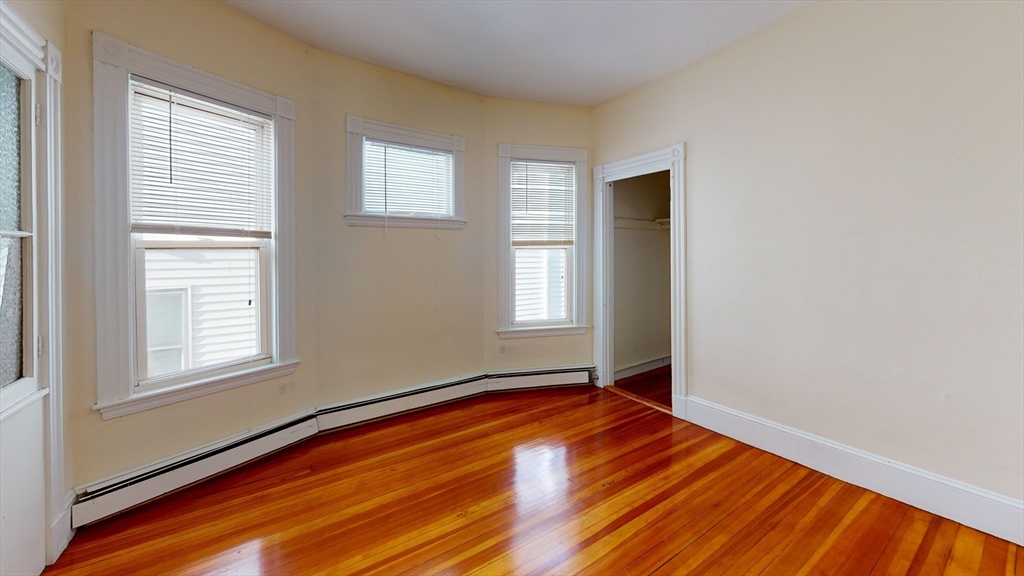 7 Sunset Street, Unit UPPR Boston, MA 02120 - Photo 4 of 7 an empty room with wooden floor and windows