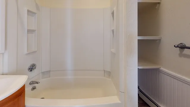 a white bath tub sitting next to a white sink