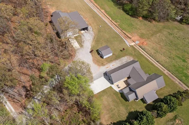 a front view of a house with a garden and yard