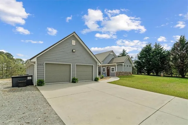 a view of a house with a yard and garage