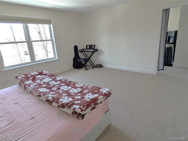 a bed sitting in a bedroom next to a window