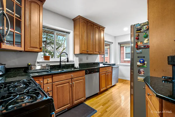 a kitchen with stainless steel appliances a stove a sink and a refrigerator