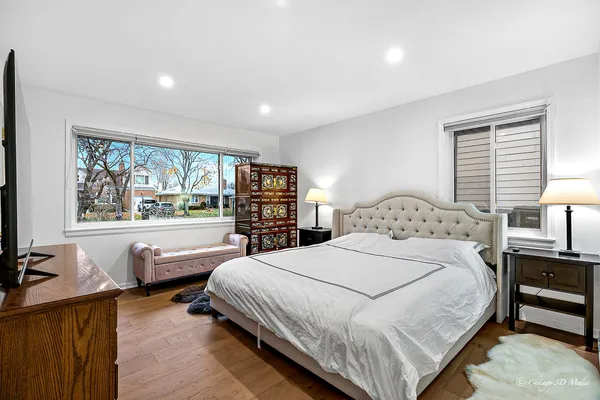 a spacious bedroom with a bed and a large window