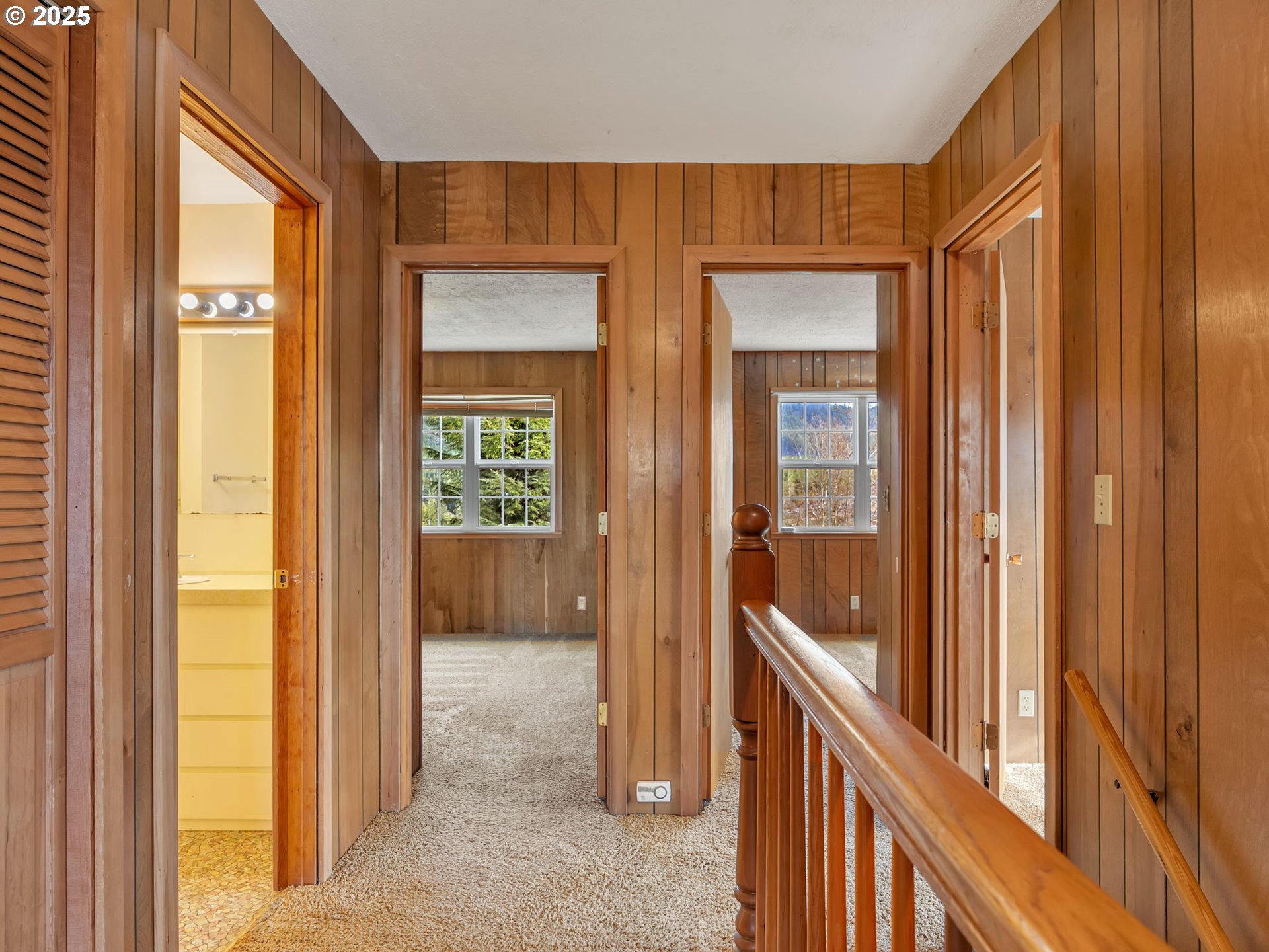 37555 Hauger Mountain Lane Seaside, OR 97138 - Photo 20 of 32 a view of a hallway with wooden floor and stairs