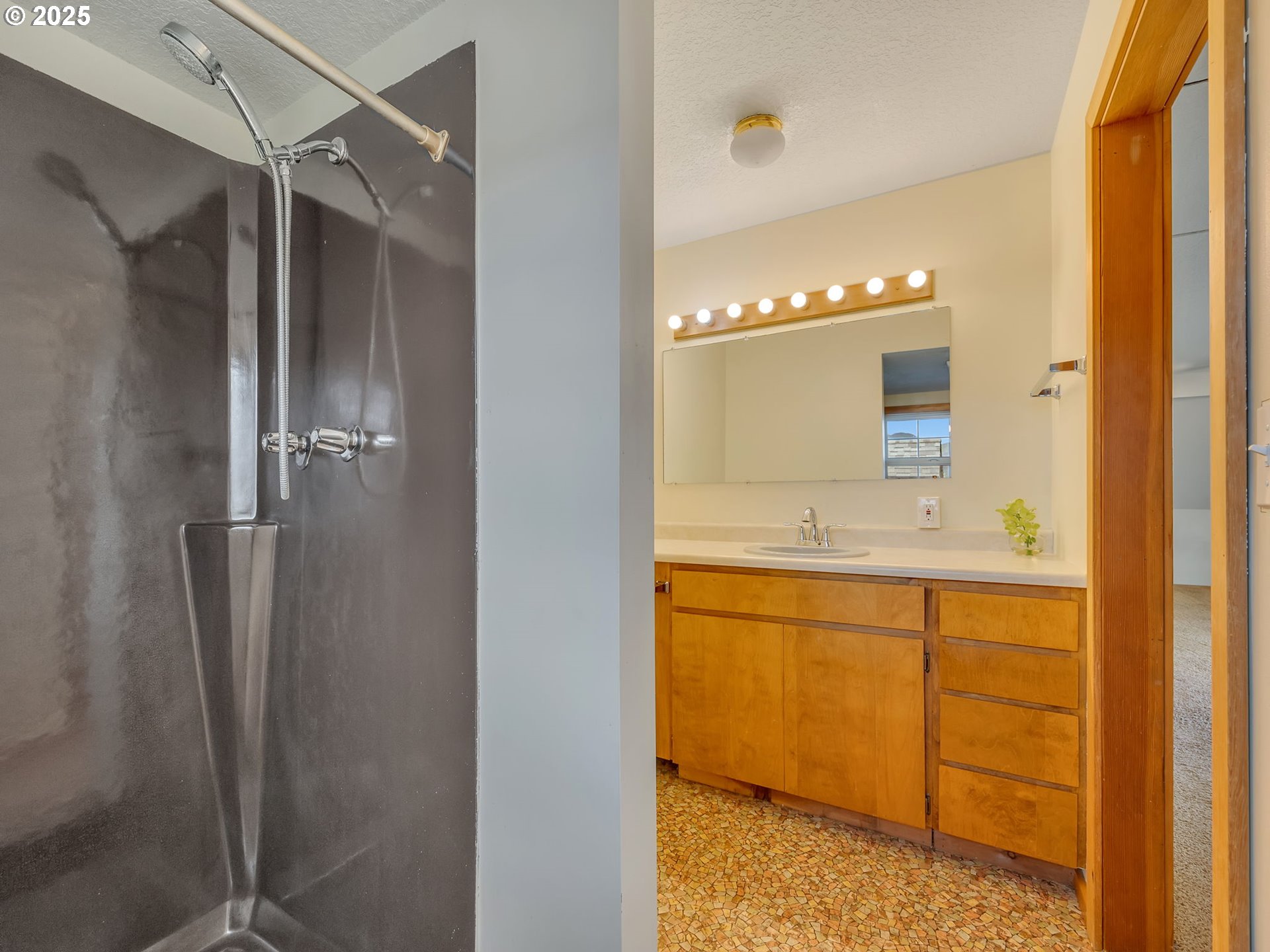 37555 Hauger Mountain Lane Seaside, OR 97138 - Photo 24 of 32 a bathroom with a double vanity sink a mirror and a shower