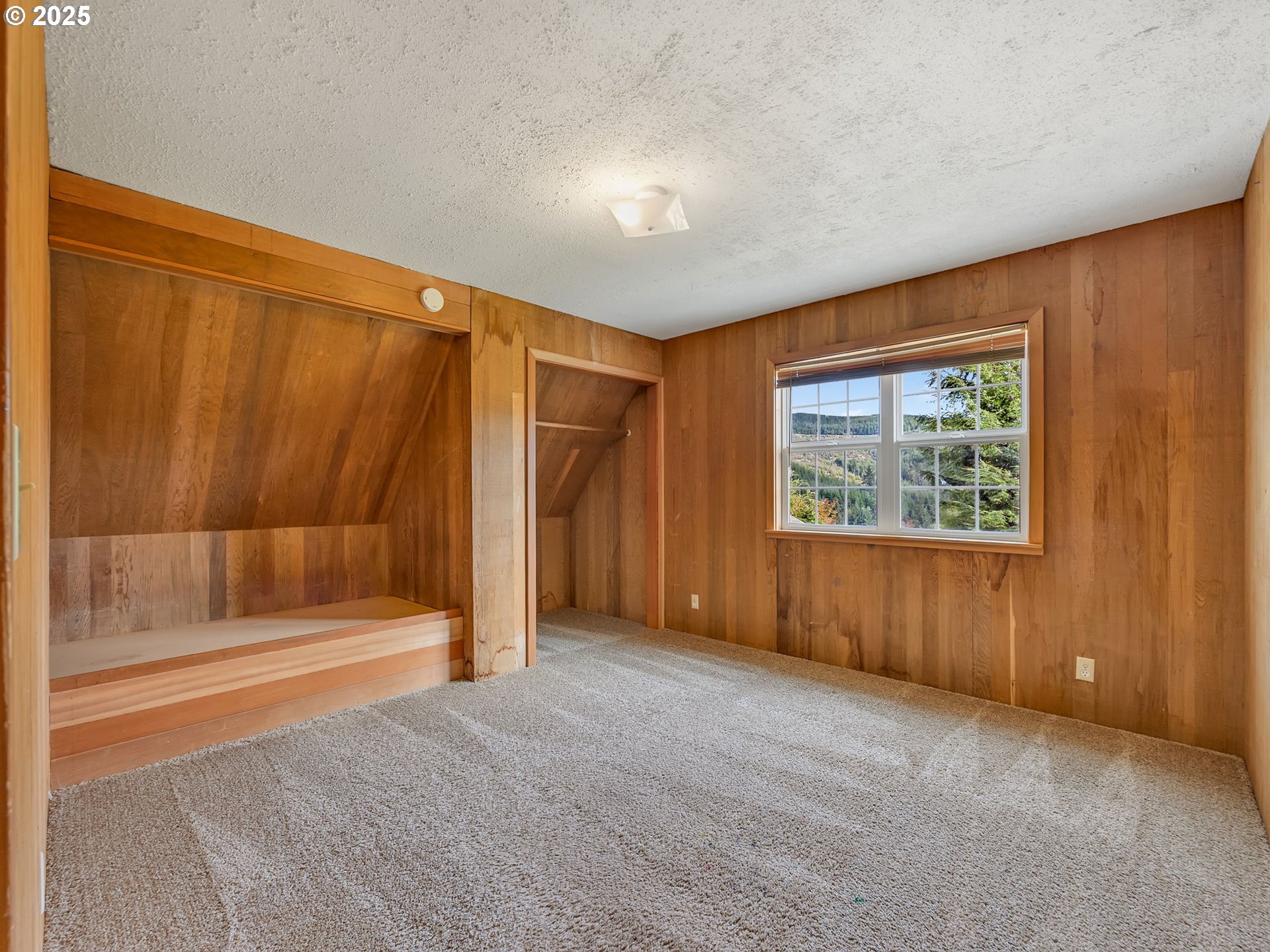 37555 Hauger Mountain Lane Seaside, OR 97138 - Photo 26 of 32 an empty room with a fireplace and large window