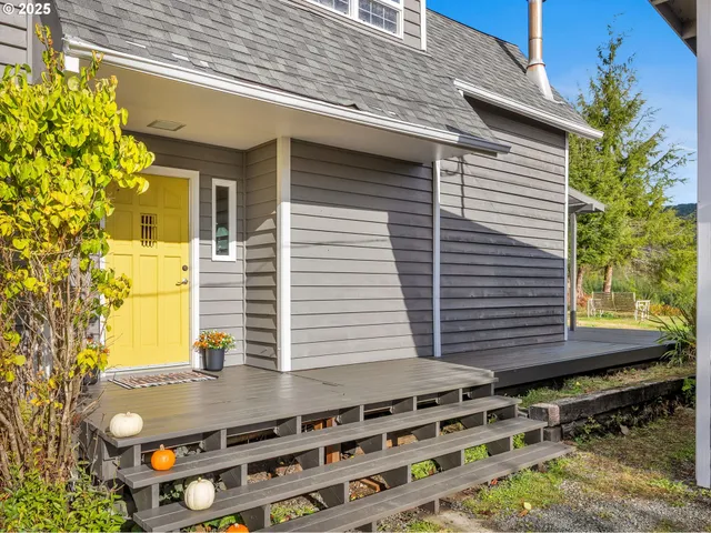 a view of a patio with a table and chairs and potted plants
