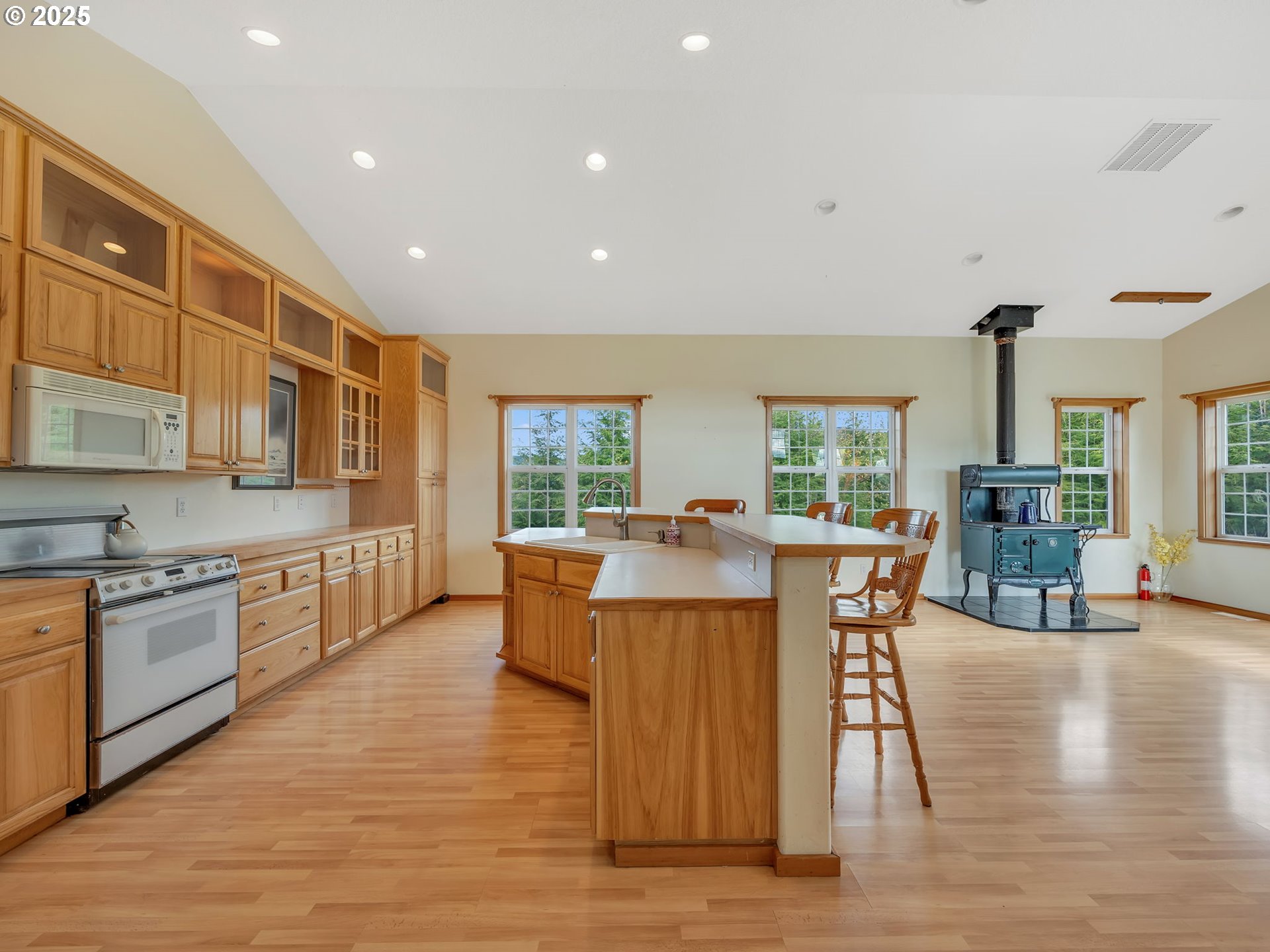 37555 Hauger Mountain Lane Seaside, OR 97138 - Photo 10 of 32 a dining hall with stainless steel appliances granite countertop wooden floor a stove top oven a dining table and chairs