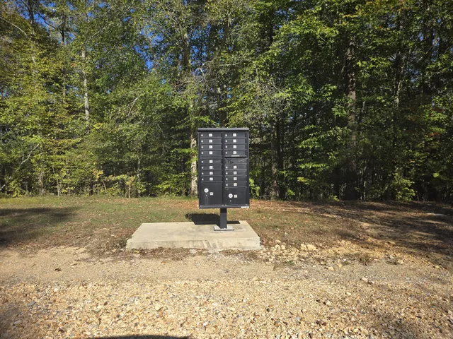 a wooden bench sitting in the middle of a yard